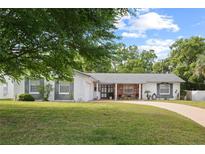 Charming single-story home with a well-manicured lawn and a curved driveway at 2506 Chinook Trl, Maitland, FL 32751