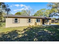 Charming single-story home with a well-maintained lawn and mature trees offering shade at 2522 Junction Rd, Zellwood, FL 32798