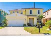Charming two-story home with a two-car garage, well-manicured lawn and inviting curb appeal at 277 Sand Ridge Dr, Davenport, FL 33896