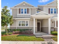 Charming two-story home with manicured lawn and inviting front porch, perfect for enjoying a relaxing afternoon at 5898 Soter Ln, Windermere, FL 34786