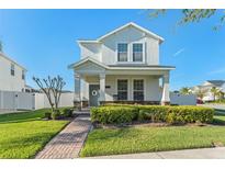 Charming two-story home with a well-manicured lawn and inviting front porch at 9844 Pecan Hickory Way, Orlando, FL 32832