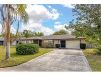 Charming single story home featuring a well-maintained lawn and a concrete driveway at 1061 Radford Dr, Deltona, FL 32738