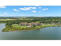 Stunning aerial view of waterfront condos, showcasing lush surroundings and lake views at 16300 County Road 455 # 704, Montverde, FL 34756