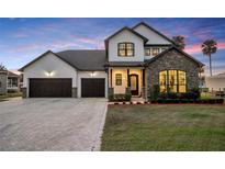 Stunning two-story home with stone accents, three-car garage and manicured lawn at 2072 Starboard Dr, Geneva, FL 32732