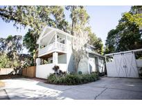 Charming two-story home with front yard landscaping and white picket fence at 2211 Oberlin Ave, Orlando, FL 32804