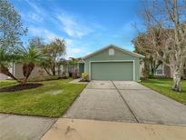 Charming single-story home featuring a well-manicured lawn, landscaping, and a two-car garage at 2701 Bullion Loop, Sanford, FL 32771