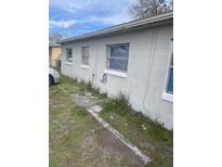 Side exterior view of a modest one-story house showing multiple windows at 5915 Colchester Dr, Orlando, FL 32812