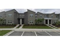 Modern townhome complex features clean lines, stone accents, and manicured landscaping at 992 Leader St, Davenport, FL 33896