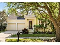 Charming single Gathering home featuring a two-car garage and well-maintained landscaping at 10081 Cobalt Bay Rd, Orlando, FL 32827