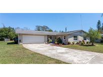 Charming single-story home featuring a spacious driveway, well-maintained lawn, and mature landscaping at 1021 Mare Bello Dr, Winter Park, FL 32792