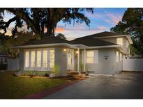 Beautiful home featuring large windows and a well-maintained yard under a majestic, mature tree at 1303 E Central Blvd, Orlando, FL 32801