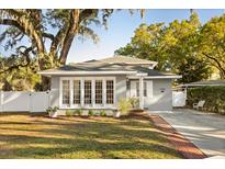 Charming single-Gathering home boasting a well-manicured lawn and a welcoming brick path to the front door at 1303 E Central Blvd, Orlando, FL 32801