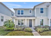 Charming two-story home with a well-manicured front yard and covered entry at 1312 Painted Bunting Ave, Oakland, FL 34787