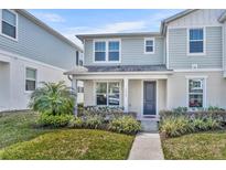 Charming two-story home with a well-manicured lawn and inviting front porch at 1312 Painted Bunting Ave, Oakland, FL 34787