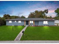 Charming single-story home with a well-manicured lawn and inviting walkway leading to the front door at 1610 Stephanie Ln, Lakeland, FL 33813