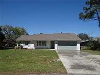 Charming single-story home with a well-manicured lawn and attached garage at 445 Live Oak Ave, Chuluota, FL 32766