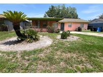 Charming single-story home featuring a covered porch and unique landscaping in the front yard at 4845 Elese St, Orlando, FL 32811