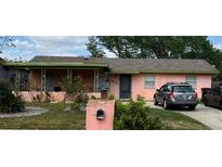 Charming one-story home featuring a covered porch and a driveway with ample parking at 4845 Elese St, Orlando, FL 32811