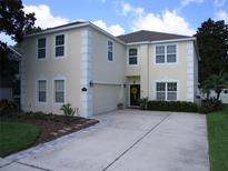 Charming two-story home featuring a spacious driveway, attached garage, and well-manicured landscaping at 506 Freeman St, Longwood, FL 32750