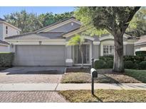 Charming single Gathering home featuring a brick paved driveway and two car garage at 6145 Froggatt St, Orlando, FL 32835