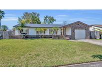 Charming single-story home with a well-manicured lawn and an attached single-car garage at 7529 Winter Shade Dr, Orlando, FL 32822