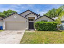 Charming single-Gathering home with a well-maintained lawn and attached two-car garage at 1028 Henson Ct, Oviedo, FL 32765