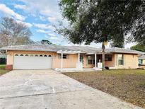 Charming single-story home featuring a two-car garage and a welcoming front entrance at 10631 Deergrass Ln, Orlando, FL 32821