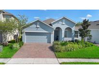 Charming single-story home featuring a well-manicured lawn and a two-car garage at 2145 Rush Bay Way, Orlando, FL 32824