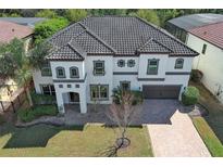 Stunning two-story home with tile roof, brick driveway and manicured lawn at 2351 Kelbrook Ct, Oviedo, FL 32765