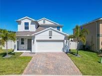 Charming two-story home with a brick paved driveway, lush lawn, and well-manicured landscaping at 2820 Black Birch Dr, Ocoee, FL 34761