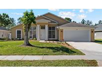 Charming single-story home with a manicured lawn and a welcoming front entrance with decorative columns at 3180 Town And Country Rd, Oviedo, FL 32766