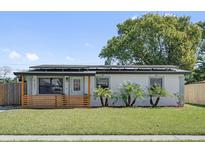 Charming single-story home with a well-manicured lawn and solar panels at 4127 Sanseviera Ln, Orlando, FL 32822