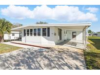 Charming single-story home with a carport and well-maintained front yard at 1028 Capella Dr, Tavares, FL 32778