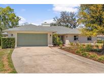 Charming single-story home with a two-car garage and beautifully landscaped front yard at 111 Woodstream Ct, Maitland, FL 32751