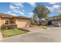 Charming single-Gathering home featuring a brick driveway and attached two-car garage, surrounded by well-maintained landscaping at 201 Walter Stevens Way, Deland, FL 32724