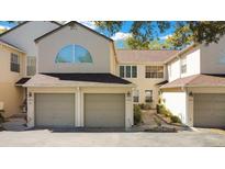 Inviting townhome featuring a two-car garage, neutral tones, and a well-maintained roof at 3038 Clubview Dr # Ge, Orlando, FL 32822