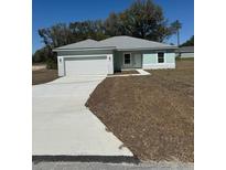 Charming single-story home featuring an attached two-car garage and freshly laid front yard at 4031 Sw 130Th Loop, Ocala, FL 34473