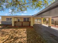 Charming single-story home featuring a covered front porch and carport at 411 Thomas Ave, Frostproof, FL 33843