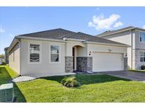 Charming single-story home featuring stone accents and a well-manicured lawn at 1232 Celery Oaks Ln, Sanford, FL 32771