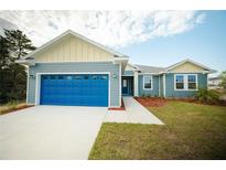 Charming single-story home with a bright blue garage door and well-manicured front yard at 1447 Kissimmee Way, Kissimmee, FL 34759