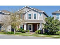 Inviting two-story home features a well-maintained lawn and lush landscaping at 15837 Sweet Lemon Way, Winter Garden, FL 34787