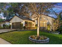 Charming home with a well-maintained lawn, lush landscaping, and a welcoming facade at 1756 Waterbeach Ct, Apopka, FL 32703