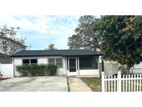 Charming single-story home with a well-maintained front yard and a black roof at 214 Lucile Way, Orlando, FL 32835