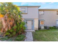 Charming townhouse featuring neutral paint, a tidy lawn, and lush landscaping in front at 3071 George Mason Ave # 5, Winter Park, FL 32792