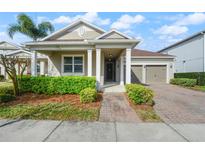 Charming single-story home with a manicured lawn and a two-car garage on a sunny day at 3242 Irish Peach Dr, Winter Garden, FL 34787