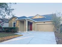 Charming single-story home featuring a well-maintained lawn, covered entry, and two-car garage at 4852 Blue Major Dr, Windermere, FL 34786