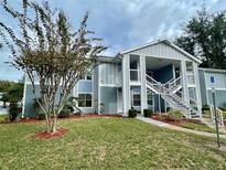 Inviting two-story condo with well-maintained lawn and appealing blue and white exterior paint at 729 Secret Harbor Ln # 105, Lake Mary, FL 32746