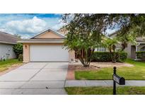 Charming single-Gathering home with a well-maintained lawn, mature landscaping, and a two-car garage at 14617 Keelford Way, Orlando, FL 32824