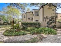 Charming two-story home with well-maintained landscaping, including a variety of plants, gravel, and a decorative black fence at 1570 Farrindon Cir, Lake Mary, FL 32746