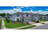 Charming two-story home with a two-car garage, brick paver driveway, and nicely landscaped yard at 2313 Ivy Harvest Pl, Oviedo, FL 32765